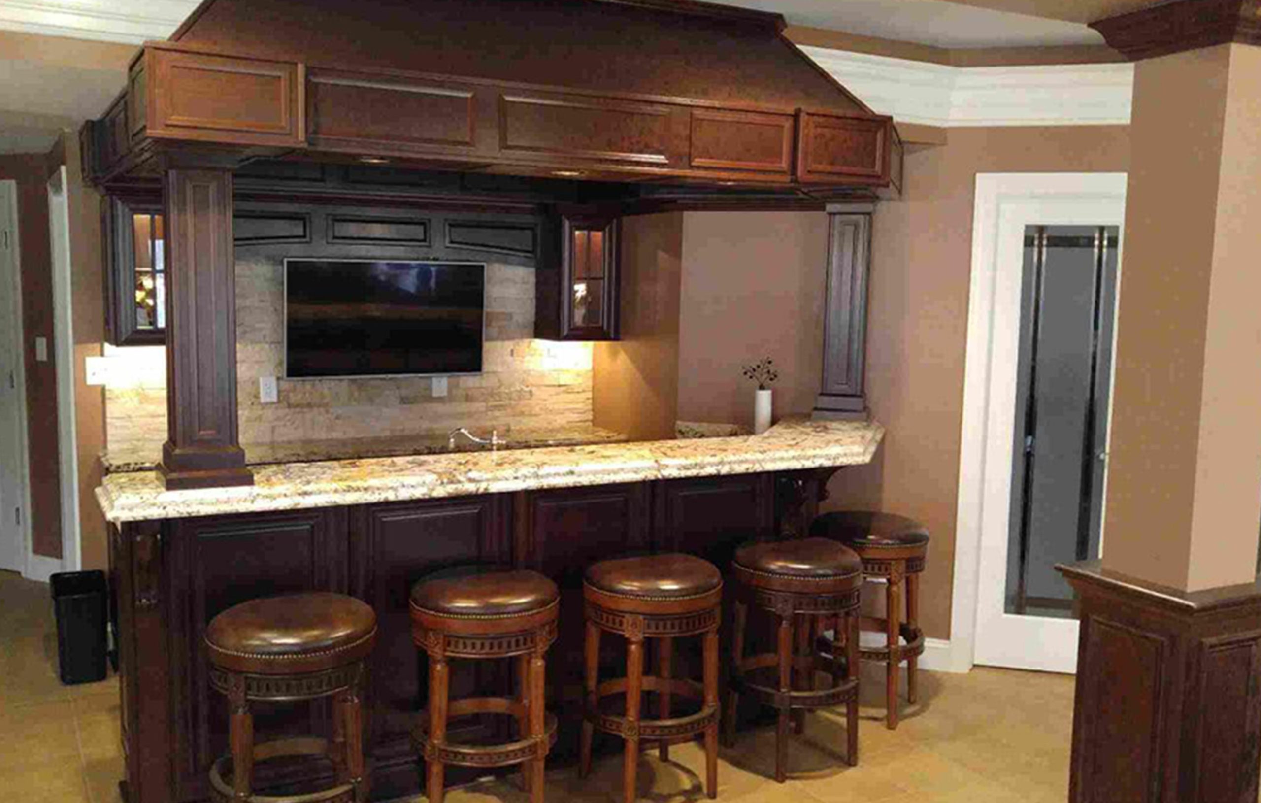 Granite top bar with wood finish and an overhang above it