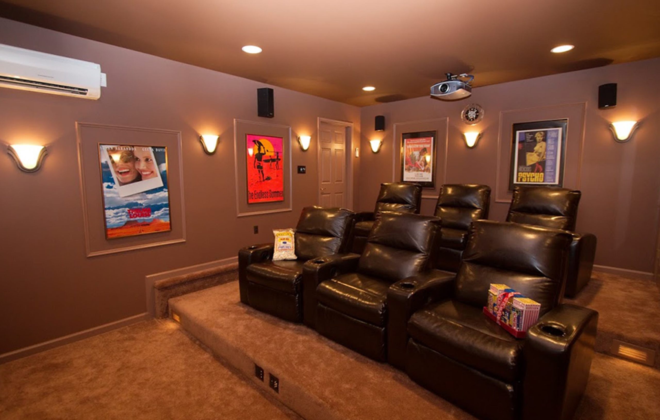 Multi-level movie room with a projector built into the ceiling