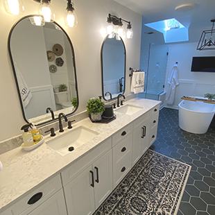 new bathroom with a vanity sink, skylight, & hexagon tiles