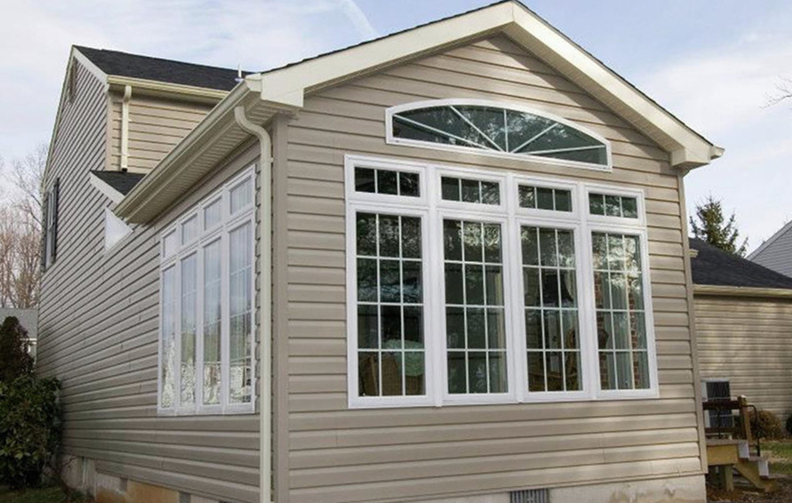 a new sunroom from the outside, including its new windows & sidings