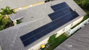 Overhead view of solar panels on residential roof.